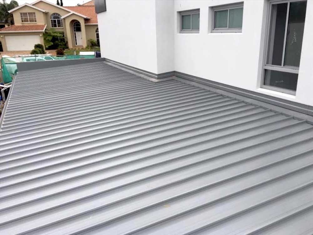 Clean metal roofline and guttering on a rendered home