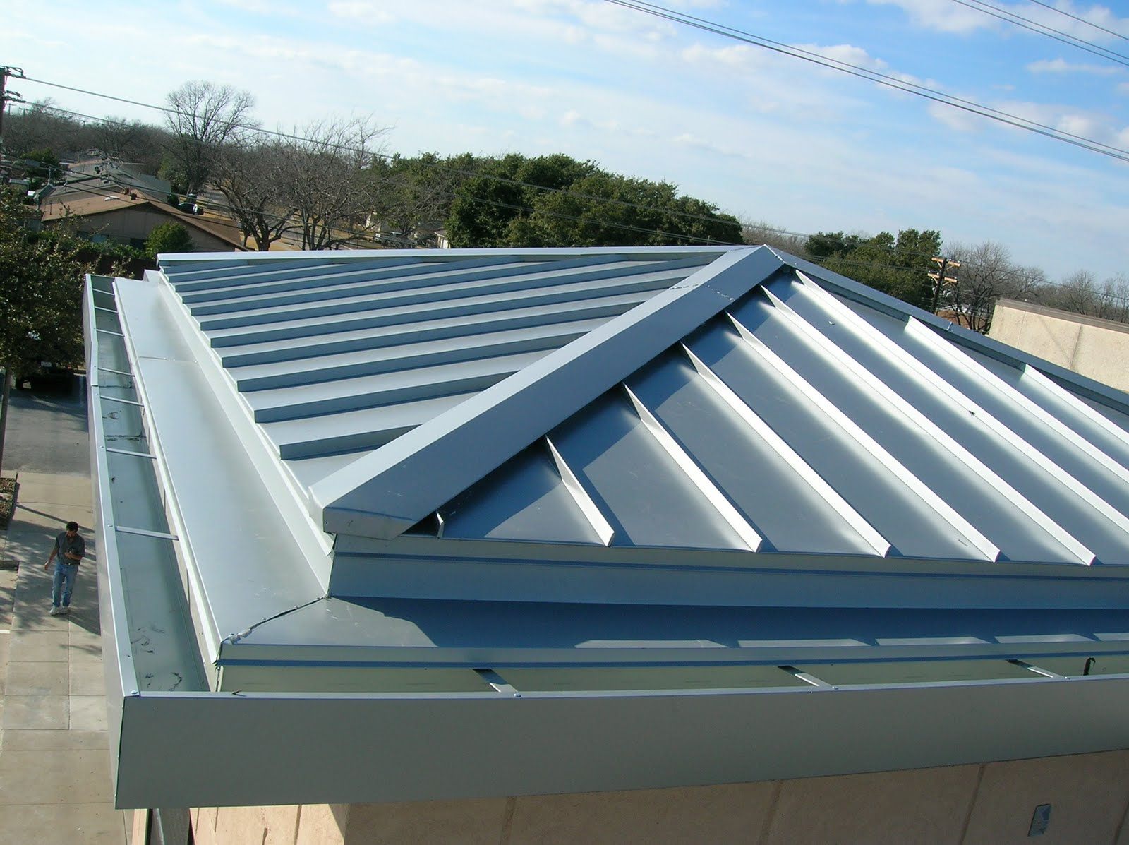 Restored standing seam metal roof in a blue grey finish