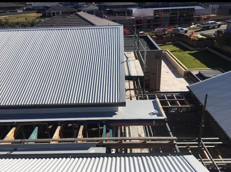 Roofer working on a metal roof installation