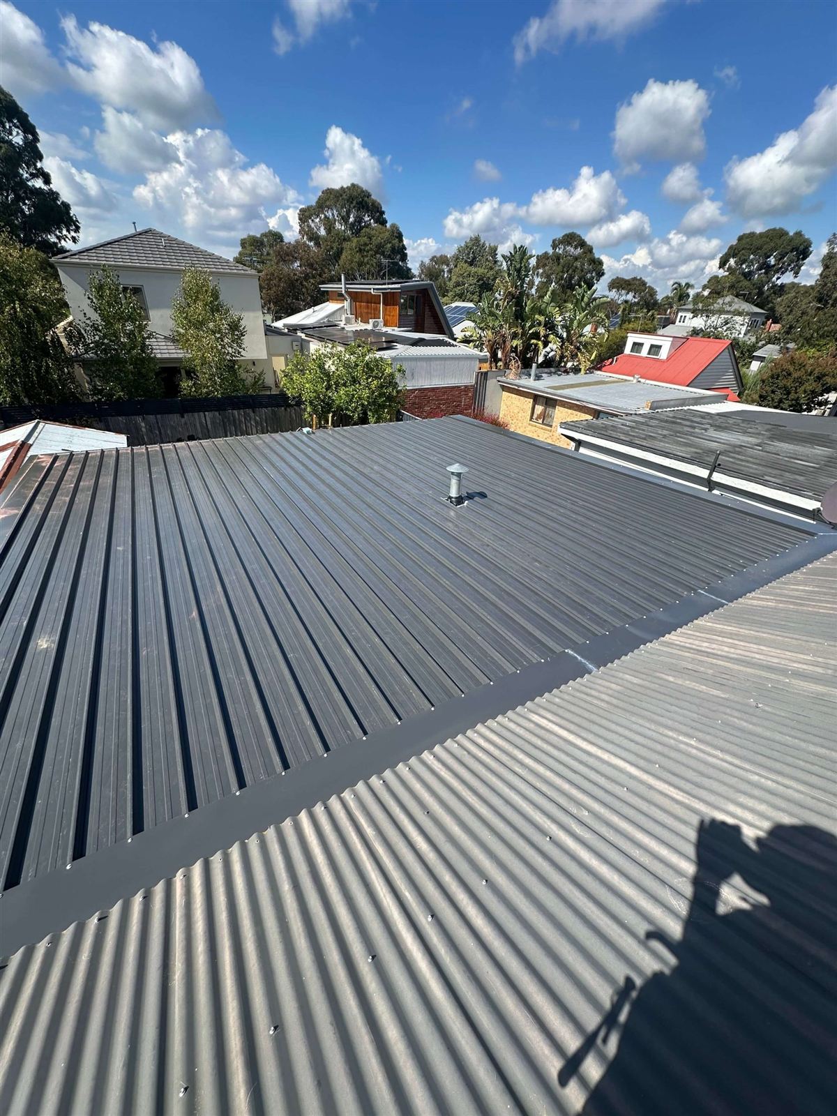 Suburban Brisbane rooftops, tile and metal roofs in Indooroopilly